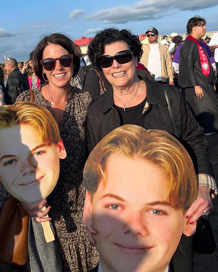 Family holding big head cutouts